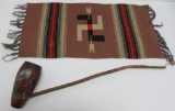 Native American souvenir pipe and South western rug