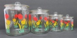 Four colorful tulip patterned covered glass canisters