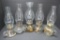 Five clear glass oil lamps with chimneys