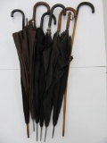 Six vintage umbrellas and wooden cane