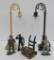 Train accessories, cast iron figures, tin trunk with hand truck and two street lights by MTH