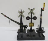 Three styles of electric train crossing signals and Lionel loading platform