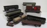 7 vintage Marx and other tin train cars and one plastic flat car