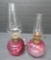 Two miniature cranberry glass finger tip and acorn and leaf lamps, 7