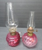 Two miniature cranberry glass finger tip and acorn and leaf lamps, 7
