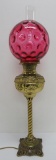 Cranberry glass thumbprint shade on brass banquet lamp, 29