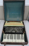 Lyric accordion with case, marbleized celluloid, ornate reticulated sound board