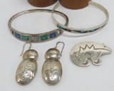Silver earrings, pin, and two inlay bracelets one Zuni