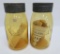 Two reproduction Ball Amber Buffalo Jars, with papework, quart