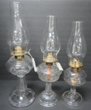 Three clear pattern glass oil lamps, 7 1/2