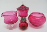 Four pieces of cranberry glass, cream, sugar, open bowl and shaker