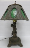 Cherub table lamp with green slag panel shade, 17