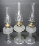Three frosted glass oil lamps, 9