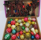 About 40 vintage ornaments and nine light strands, some with Noma tags