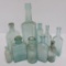 10 aqua colored bottles, medicines, 3