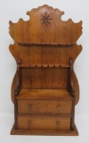 Two drawer wooden display rack with star spoon carving on back,
