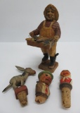 Four wood carvings, three are bottle corks