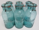 Six 1/2 gallon blue Ball Canning jars with bail glass lids
