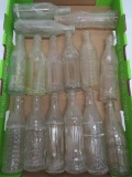15 clear and embossed soda bottles, 8