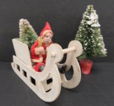 Clay face Santa in sleigh and bottle brush tree