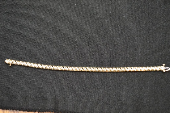 Gold (?) Tennis Bracelet W/ 42 Round Stones And Security Latch
