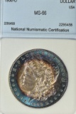 1900-O Rainbow/Bullseye Morgan Silver Dollar - MS 66, Slabbed by NNC