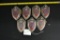 Seven Knight Shield emblems, some have cracks