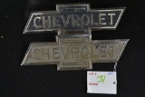 two Chevrolet tin badges, 8 inches long