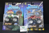 Pair of Muscle Machine Adult Collectibles of The Wolf Man and Jurassic Park Monster Trucks; 1/64 Sca