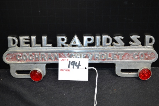 Dell Rapids, SD, Advertising Cast Metal License Plate Topper w/Red Jeweled Reflectors; 10"x3"