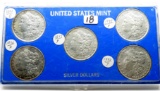 5 Morgan $ in display case1879; 1882; 1883-O; 1889; 1890 with COA