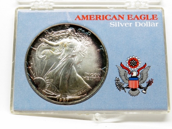 1987 Silver American Eagle in holder, BU, rim toning