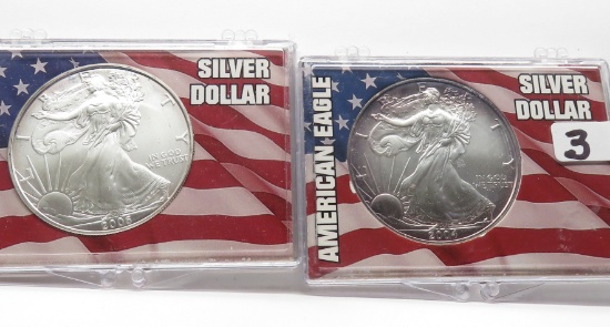 2 Silver American Eagles BU in flag holders: 2004 mauve toning, 2005