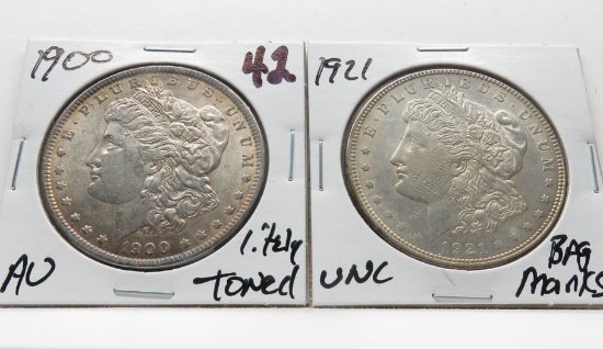 2 Morgan $: 1900 AU lightly toned, 1921 Unc bag marks