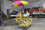 Tricarga Go Ray bike with large front basket cargo area and umbrella.