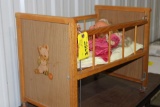 Child's doll bed on casters & dolls