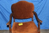 Brown upholstered wooden arm chair.