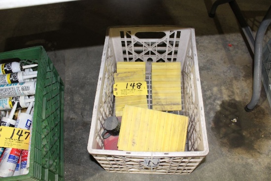 Crate of tire chokes and gas can.