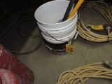 Pail of long handle brushes.