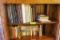 Norwell yearbooks and other books on top 2 shelves of cabinet