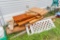 Large assortment of project lumber including 1 4x8 piece of osb inside building
