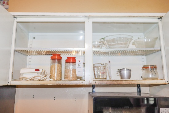 Pyrex clear measuring bowls (3) Fire King measuring cups and other items in cabinet