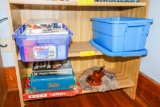 Videos, games and cd's on bottom 2 shelves toy violin