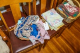2 baskets with aprons placemats and kitchen linens