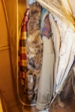Hanging Coat bag with several coats and jackets