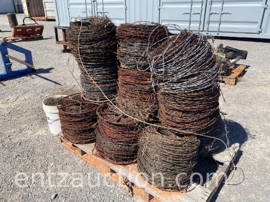 12 ROLLS OF USED BARBED WIRE AND BUCKET OF