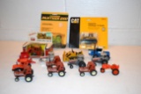 Assortment of 1/64th scale tractor, some on cards and loose, Hesston, Allis Chalmers, Steiger, Cat,