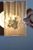 Glass Negative of Children In Chair Holding Hands