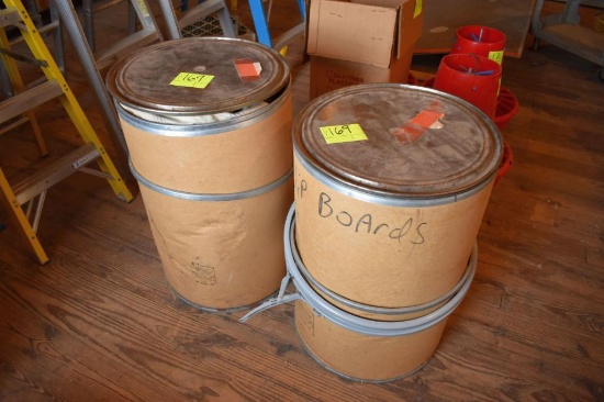 2 barrels full of burlap and plastic bags, located building 5
