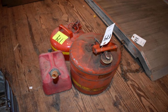 2 metal gas cans, 1 plastic gas can, located building 5